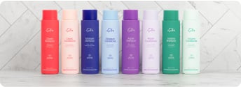 Flaconi di shampoo eSalon allineati in fila.